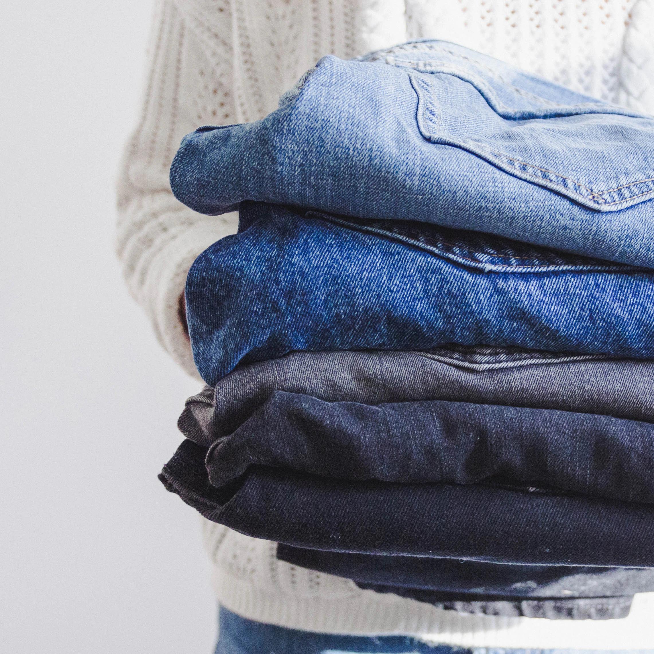 Stack of jeans of different colors