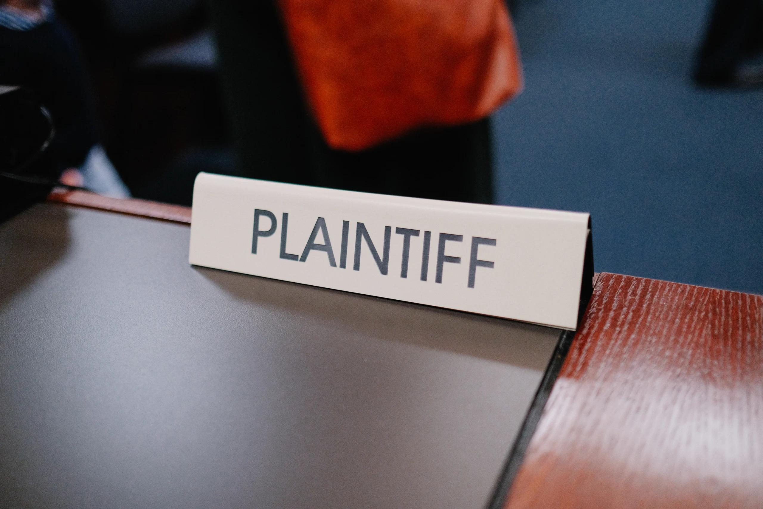 A close up of a sign that says "Plaintiff"